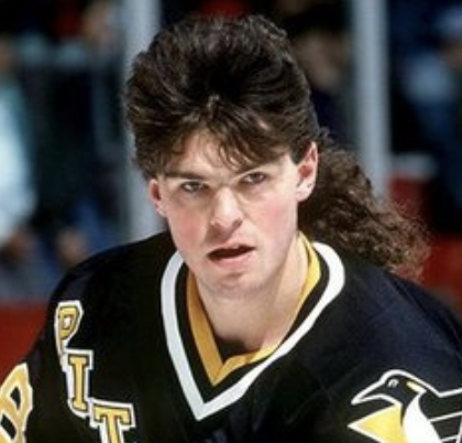 Jaromir Jagr looks at the camera while skating on the ice, sporting a mullet while playing for the Pittsburgh Penguins.