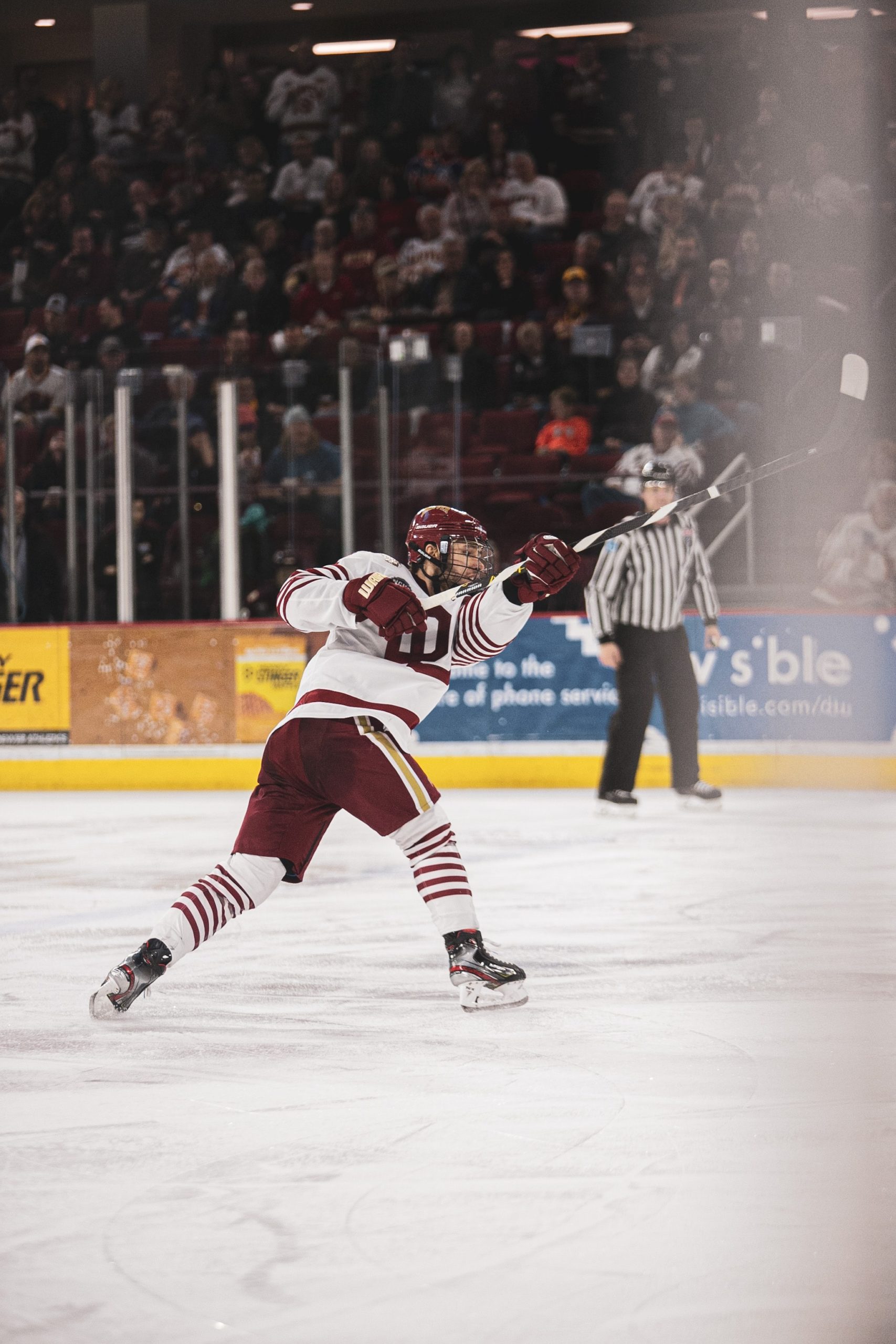Logan Weaver follows through on a shot during a hockey game.
