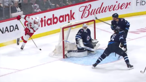 Andrei Svechnikov attempts "The Michigan" wraparound goal in a game against the Winnipeg Jets.