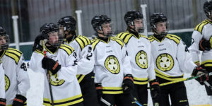Brynas IF youth hockey players lined up across the blue line, looking across the ice.