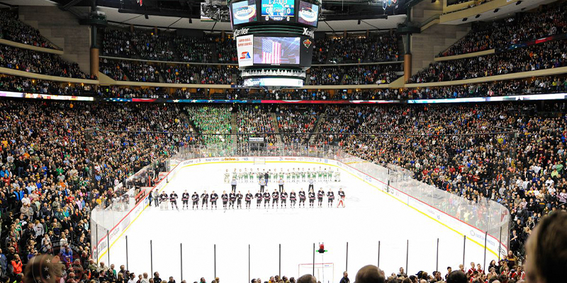 Two teams stand at the blue line of a sold out 20,000-seat Xcel Energy Center.