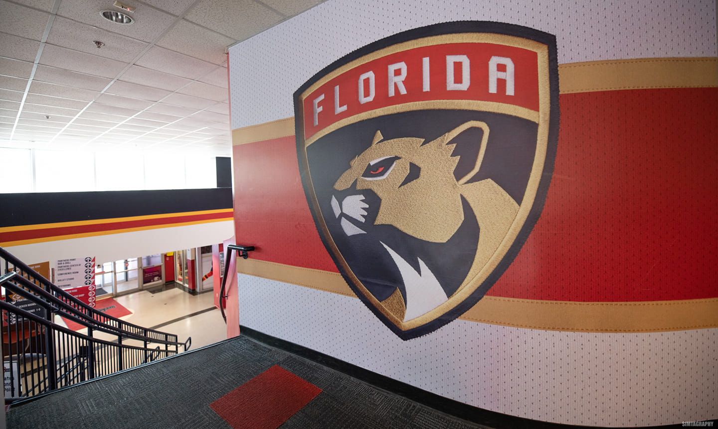 Florida Panthers logo on a wall leading towards the stairway of a building.