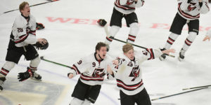 Eden Prairie players celebrate by throwing gloves, sticks and helmets into the air.