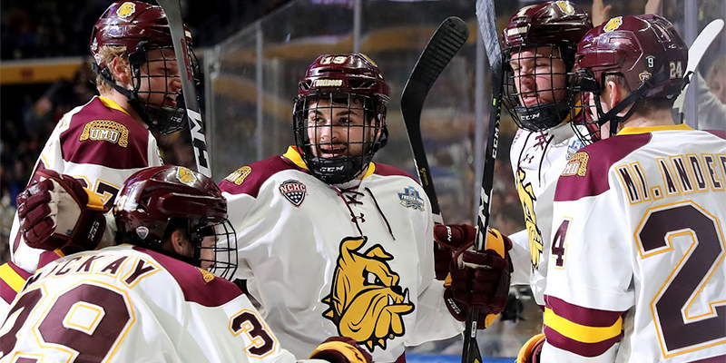 Five players from Minnesota-Duluth celebrate after scoring a goal.