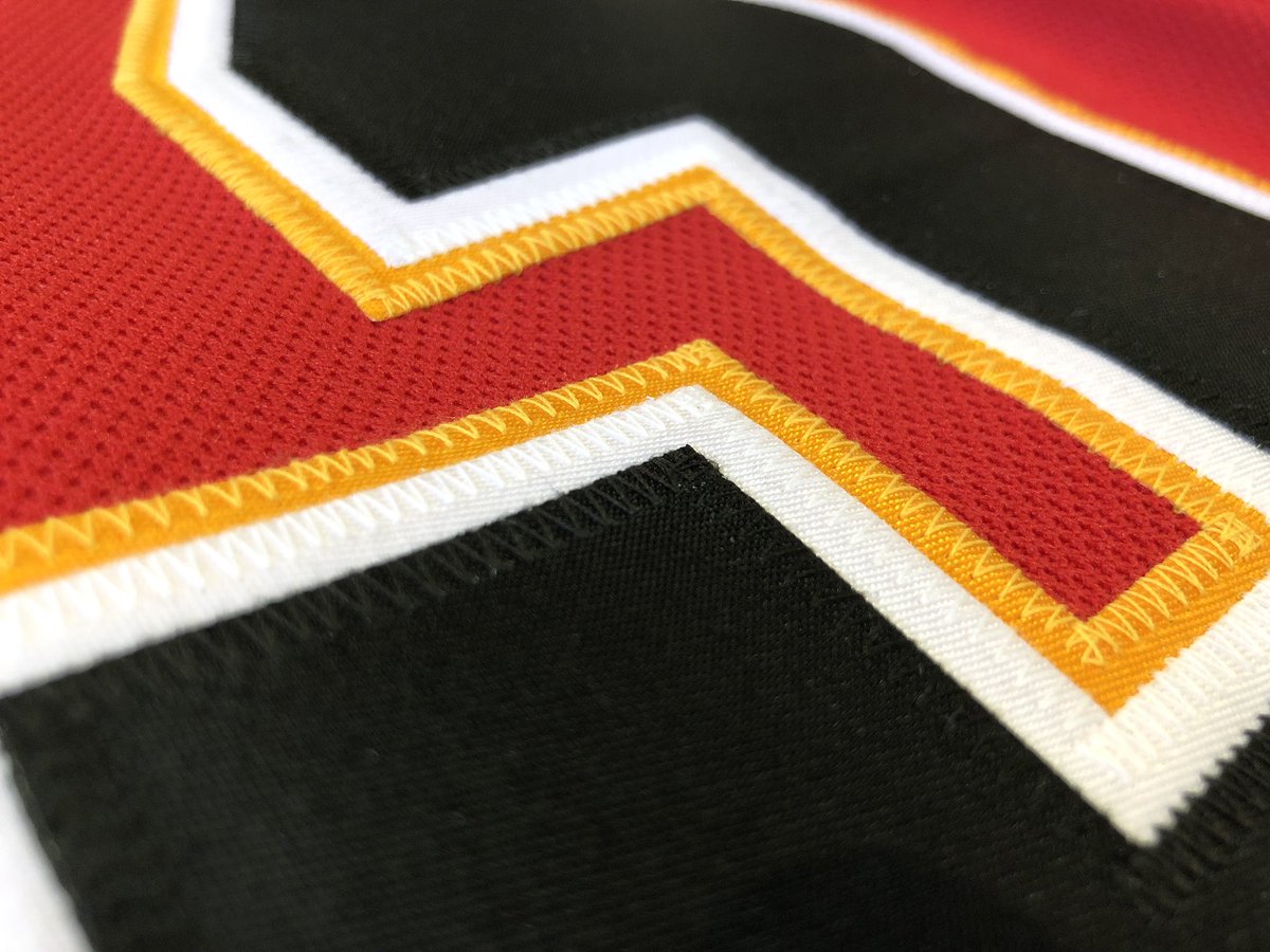 Close-up on a jersey showcasing the threading and stitching.