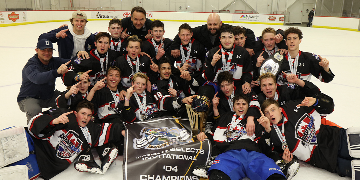DraftDay Black poses on the ice in celebration after winning the 2019 World Selects Invitational.