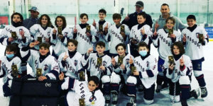 A youth team from Exposure Hockey poses for a championship photo on the ice.