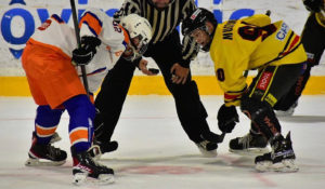Sisu Mustonen, forward for 2008-born Finnish youth hockey team KalPa Keltainen sets up for a face off.