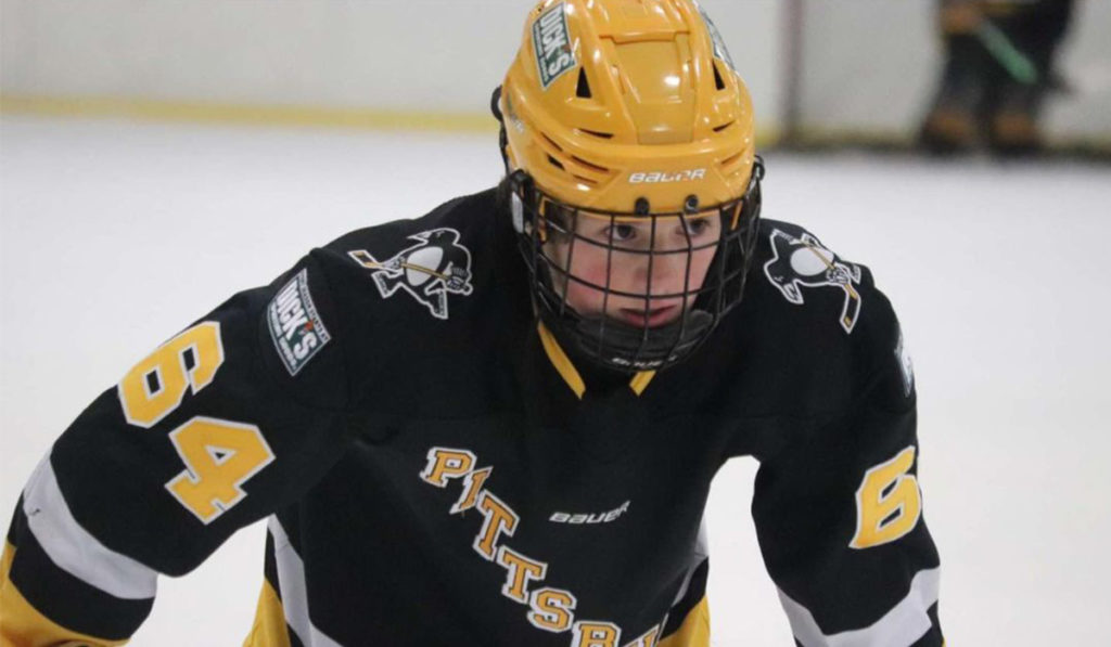 Drew Glasser, forward for 2008-born U.S. youth hockey team Pittsburgh Penguins Elite sets for a faceoff.