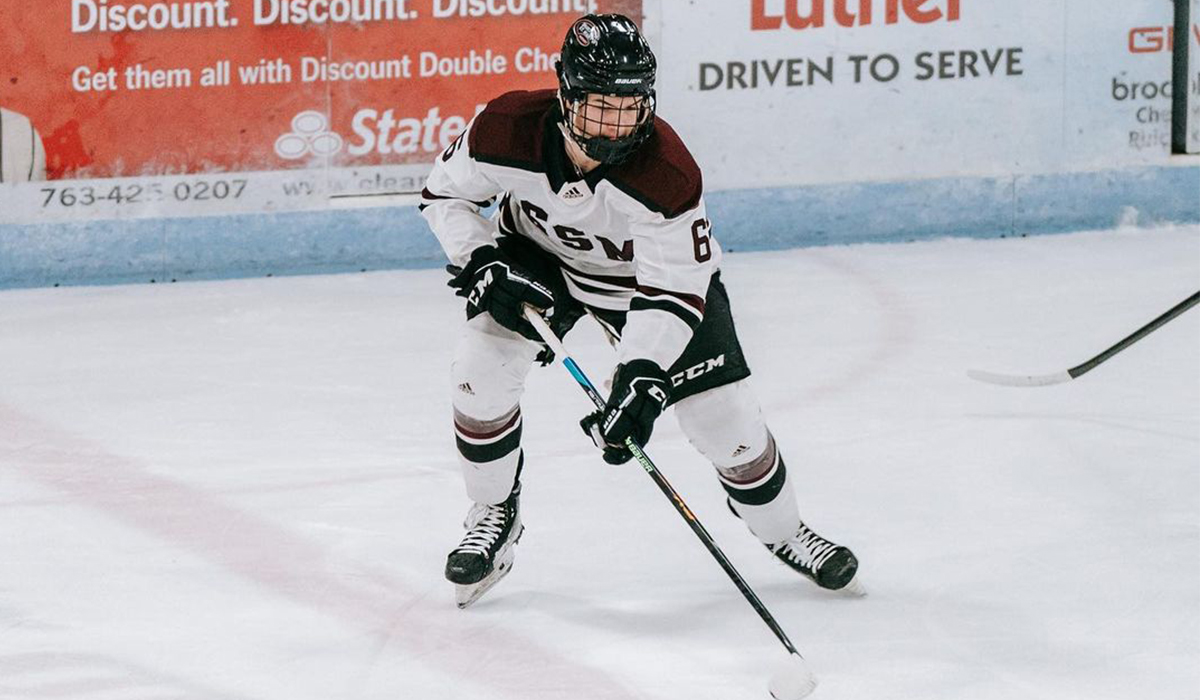 Kyle Heger, forward for 2007-born U.S. youth hockey team Shattuck-St. Mary's skates with the puck.