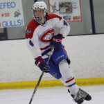 Jesse Orlowsky, player for 2008-born U.S. hockey team Long Island Gulls skates with the puck.