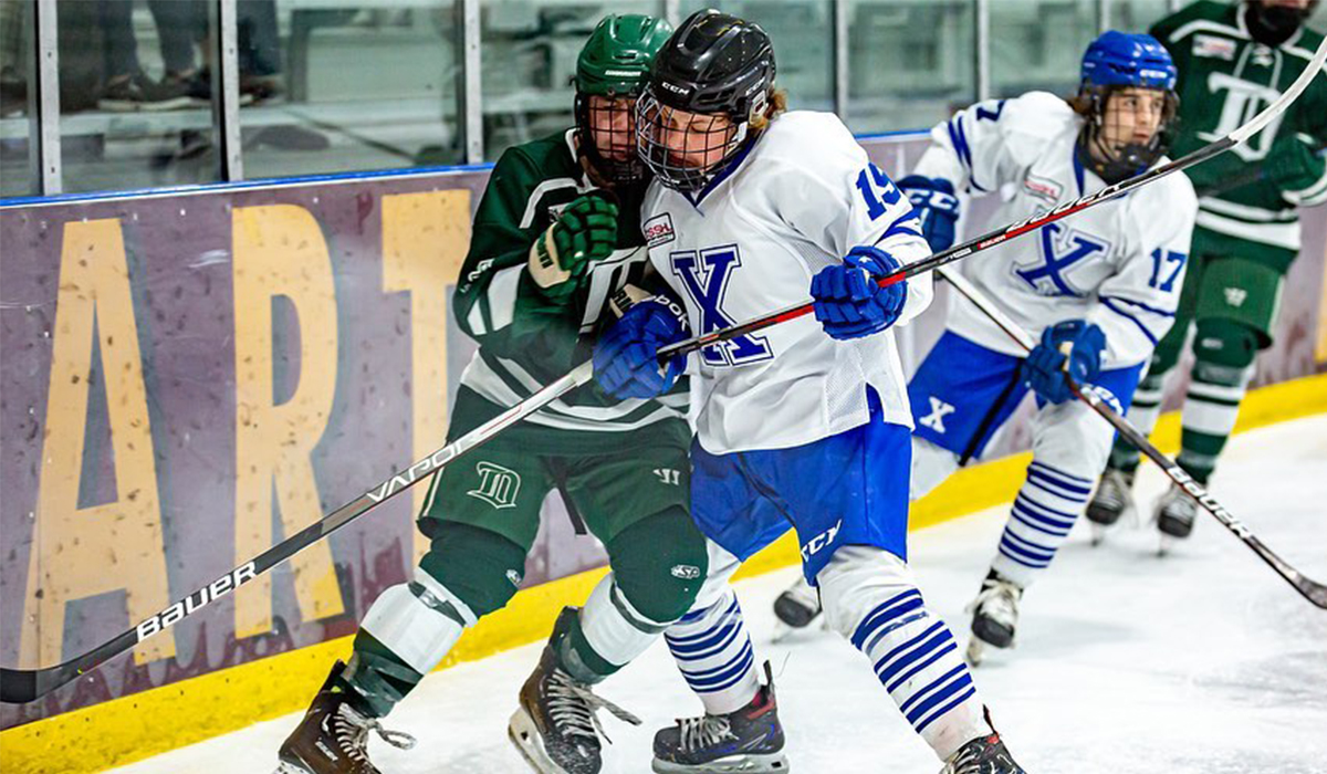 Maddox Rose, forward for 2008-born Caandian youth hockey team Northern Alberta Xtreme, battles for a puck.