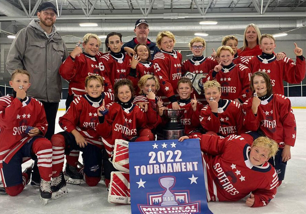 The Spitfires Hockey Program Canadian youth hockey team celebrates winning the D2 2011 Division at the 2022 Montreal Meltdown tournament.